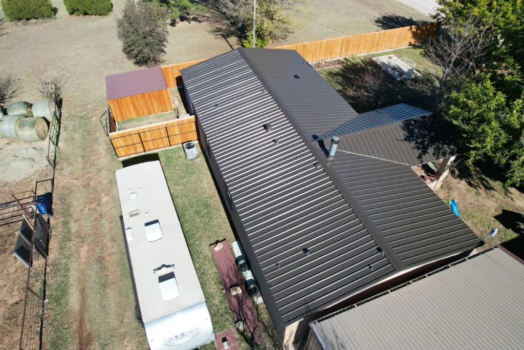 Aerial view of metal roof installation on a residential home