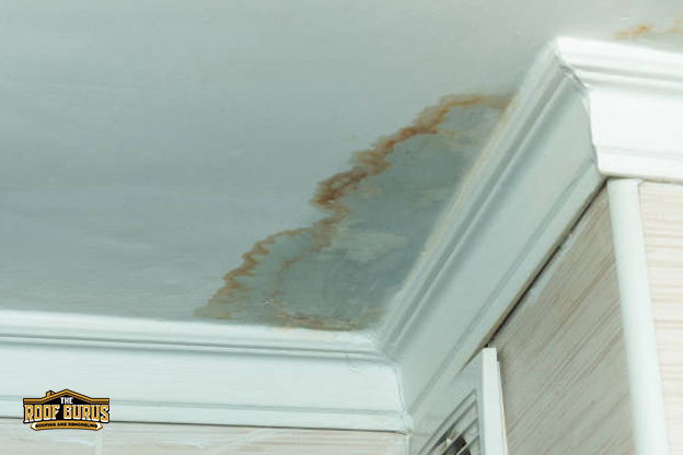 Ceiling water stains caused by flat roof drainage and moisture issues