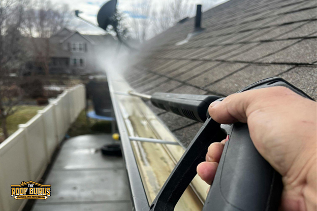 Gutter inspection showing water flow and debris buildup along roof edge