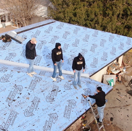 Professional roofing crew performing a residential roof inspection