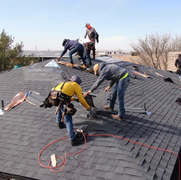 Roofers working on a full roof replacement